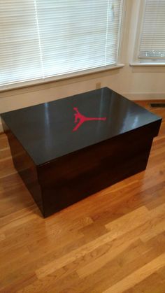 an air jordan coffee table in the corner of a room with hardwood floors and windows