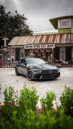 a grey mercedes parked in front of a restaurant