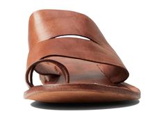 Featuring wide straps on the upper, the Free People™ Abilene Top Loop Sandal offers a unique look..Leather upper, lining, and insole..Slide-on style with toe loops..Open round toe..Flat silhouette..Cushioned footbed with branding detail..Leather outsole..Imported..Product measurements were taken using size EU 39 (US Women's 9), width M. Please note that measurements may vary by size..Measurements: Heel Height: 3/4 in Weight: 7 oz Brown Leather Footbed Slides For Spring, Chic Brown Slides With Leather Footbed, Brown Slide Mules For Spring, Leather Slides With Leather Lining For Beach, Summer Beach Toe Loop Slides, Summer Double Strap Sandals With Leather Sole, Summer Slip-on Mules With Heel Loop, Adjustable Sandals With Leather Lining For Spring, Spring Beach Slides With Toe Loop