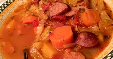 a bowl filled with meat and vegetables on top of a green and white checkered plate