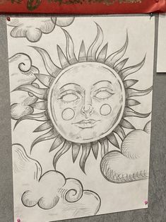 a drawing of a sun and clouds on a piece of paper