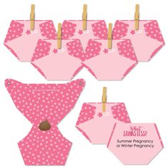 pink and white polka dotty baby diapers hanging from clothes pins