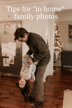 a man holding a child upside down on the floor in front of a refrigerator with text overlay that reads tips for in home family photos