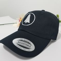 This hat is made in the USA, so wear it proud! It's unstructured with a curved visor and adjustable strap, and an American flag sewn on the back. PINE TREE Hat / Wildlife Cap / Hiking Baseball Cap / Adventure Custom Embroidery / Best Friend Gift / Camping Embroidered Hat / Forest Woods * 100% washed cotton chino twill * Unstructured, 6-panel, low-profile * Adjustable strap with hide-away buckle - US FREE SHIPPING! - High Quality - Closure: Self-fabric adjustable strap slide closure with buckle. Curved Bill Fitted Hat With Embroidered Logo, Custom Embroidered Cotton Trucker Hat With Curved Bill, Adjustable Cotton Dad Hat With Custom Embroidery, Cotton Hats With Custom Embroidery And Curved Brim, Curved Bill Hat With Embroidered Logo, Adjustable Hats With Embroidered Patch And Curved Brim, Adjustable Hat With Embroidered Patch And Curved Bill, Embroidered Patch Snapback Hat With Curved Brim, Adjustable Dad Hat With Embroidered Patch