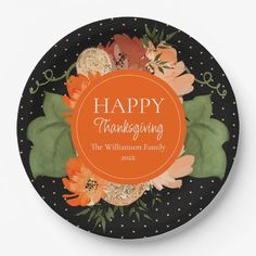 a black plate with orange flowers on it and the words happy thanksgiving written in white