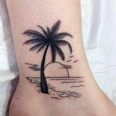 a small palm tree on the ankle tattoo design for women and men, with an ocean scene in the background