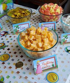 a table topped with bowls filled with candy