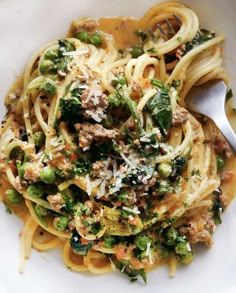 a white bowl filled with pasta and vegetables