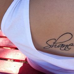 the back of a woman's stomach with a tattoo that says shame on it