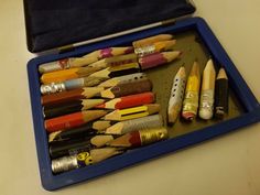 a blue case filled with lots of different colored pencils