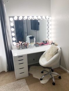 a desk with a chair, mirror and lights on it