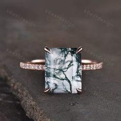 a green and white marble ring with diamonds on the sides, set in 18k rose gold