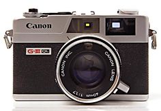 an old camera with a lens attached to it's front end, on a white background