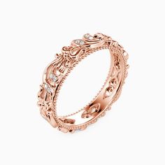 an intricate rose gold wedding ring with diamonds