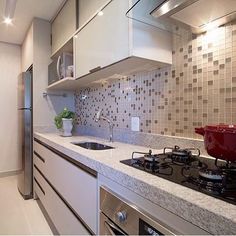 a kitchen with a stove top oven next to a counter