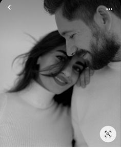 a man and woman are cuddling close to each other in black and white photo