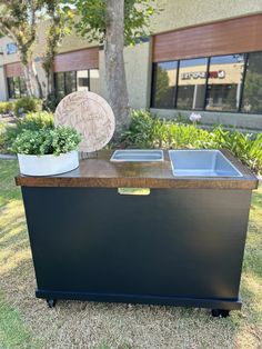 an outdoor trash can with a planter on top