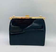 "Vintage Reversible Purse 3 in 1 Needlepoint/ Navy Blue and Black Patent Leather Top Handled Purse The purse measures 8\" tall and the handle adds an additional 5\" 2.5\" wide 9\" long clear lucite handle attached. The purse opens via the latch on top and has an inside pocket The needlepoint cover can detach from the sides revealing a matte navy blue purse, or you can flip the floral side over and attach the patent leather black cover making this purse the only one you'll ever need! SHIPPING est Evening Pouch Box Bag, Chic Rectangular Coin Purse For Formal Occasions, Compact Formal Bag With Gold-tone Hardware, Compact Formal Bags With Gold-tone Hardware, Formal Compact Bag With Gold-tone Hardware, Elegant Pouch Bag With Snap Closure, Elegant Square Coin Purse For Everyday Use, Formal Pouch Box Bag With Top Carry Handle, Chic Formal Rectangular Coin Purse