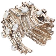 This stunning and sculptural hand wrought sterling silver cuff bracelet has 15 real pearls set in a protruding form, and the silver looks like it has been folded and creased. It has good weight to it. It is marked "925". It has a signature on it but it is illegible. It may have been one of a kind and or custom madeIt is a real conversation piece. This needs a large wrist and a substantial arm. We would say this will fit a large wrist size of 7.5, 8" or larger. The opening gap in the back is 1" w Silver Bracelet Designs, Large Cuff Bracelet, Pearl Cuff Bracelet, Engraved Cuff, Pearl Cuff, Gold And Silver Bracelets, Wide Cuff Bracelets, Cuff Jewelry, Sterling Silver Cuff Bracelet