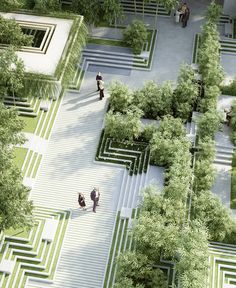 an aerial view of two people walking through a mazed area with trees and bushes