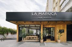 the entrance to la maruccia san francisco is shown in black and white with wood accents