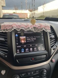 the dashboard of a car with an app on it's screen and pink lace