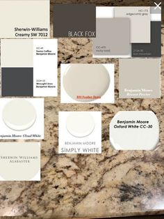 some white and gray paint samples on a counter