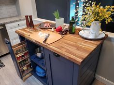 a kitchen island with cutting board, knifes and other utensils on it