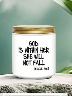 a white candle with a gold lid and the words god is within her she will not fall