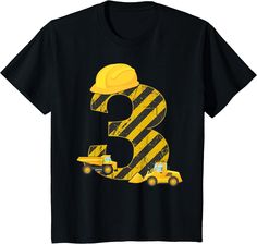 a black shirt with the number three on it and construction trucks in front of it