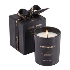 scented candle in black box with ribbon on the top and packaging behind it for scented candle