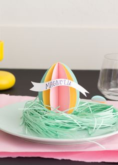 a plate with an egg on it and a sign that says magiclia sitting in the nest