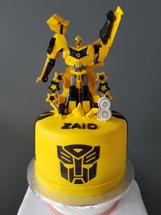 a yellow cake with a transformer figure on top