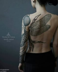 the back of a woman's body with dragonfly tattoos on her upper half