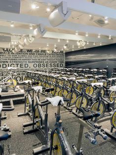 an indoor gym with rows of stationary bikes