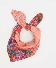 an orange and pink scarf with flowers on it