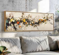 a painting hanging on the wall above a couch