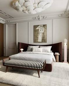 a large white bed sitting in a bedroom on top of a hard wood floor