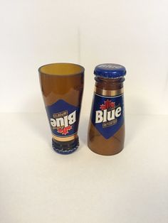 a shot glass next to a blue bottle