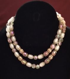 The Hobe 2 Strand Iridescent Pink and White Glass Bead Necklace is beautiful and unique. The beads are made of iridescent pink and white glass, and the necklace is 18 inches long. This necklace is perfect for adding a touch of elegance to any outfit. Every order arrives in a beautiful gift bag. White Glass Beaded Necklaces With Polished Beads, White Double Strand Beaded Necklace For Party, Elegant Iridescent Glass Necklaces, Glass Beads Necklace, Costume Fashion, Hippie Necklace, Glass Bead Necklace, Robins, Beads Necklace