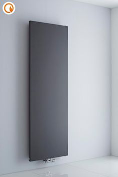 a modern radiator mounted on the wall in an empty room with white walls