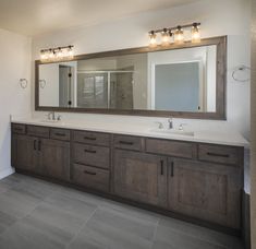 a bathroom with two sinks and a large mirror