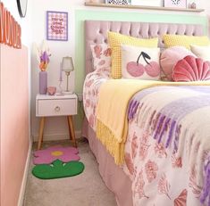 a bedroom with pink and yellow decor on the walls