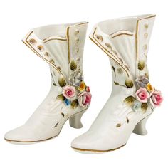 pair of white boots with flowers on them