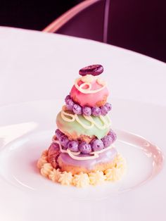 a white plate topped with a cake covered in frosting and sprinkles