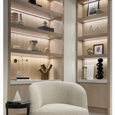 a white chair sitting in front of a book shelf