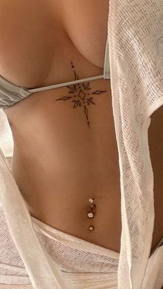 a woman with a cross tattoo on her stomach