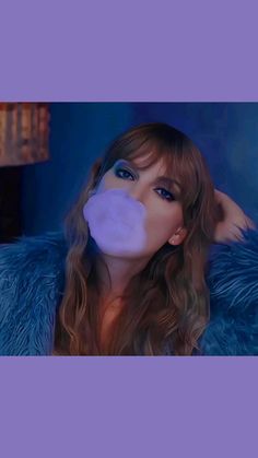 a woman with long hair and blue fur coat blowing bubble