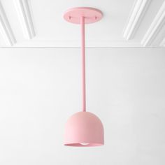 a pink light fixture hanging from the ceiling