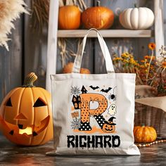 a trick - or - treat bag with the word richard on it next to pumpkins